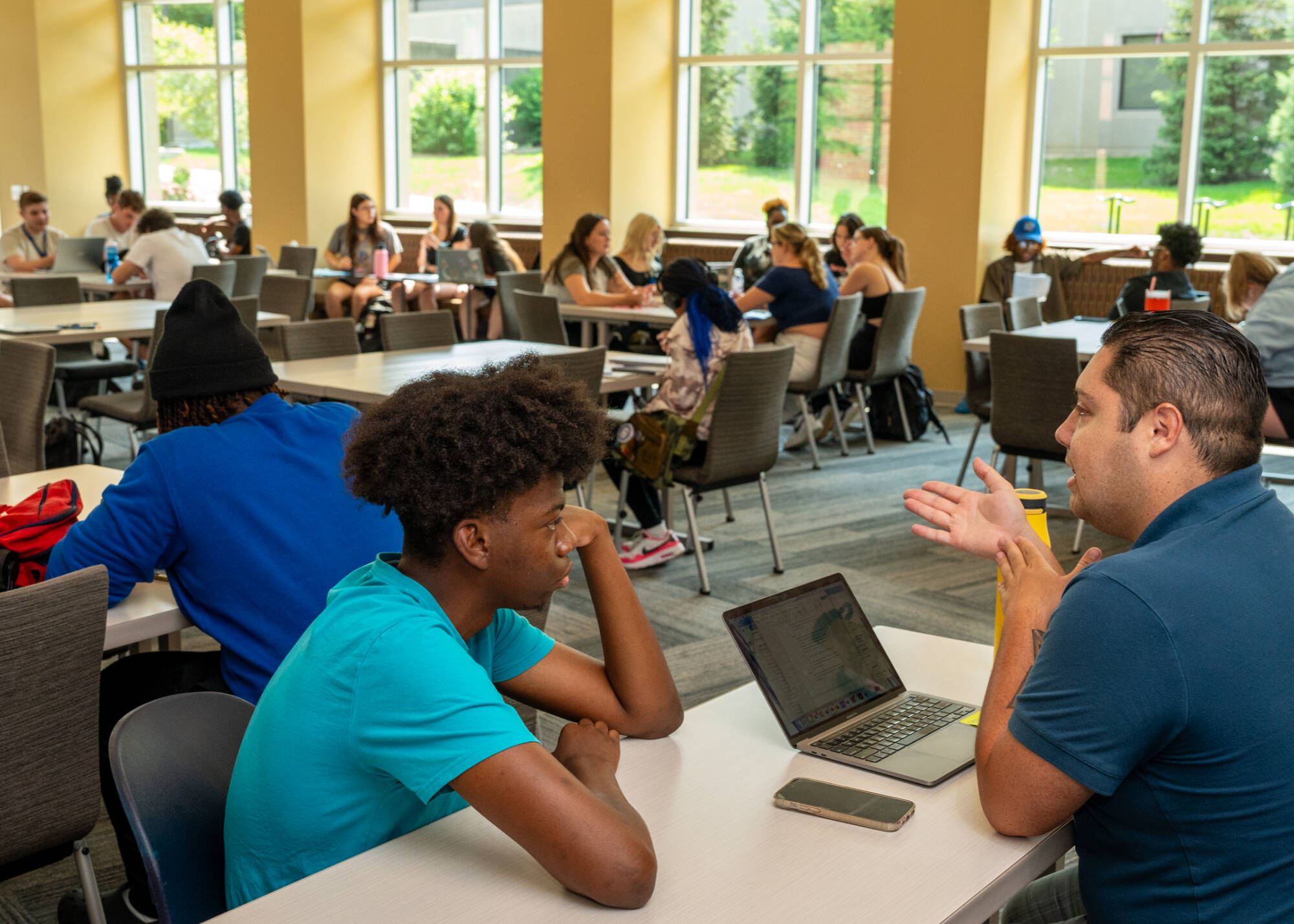 GVSU photography student Roderick Clark, left, talks with student success coach Adrian Hall as part of the Oliver Wilson Scholars program at the Holton-Hooker Learning and Living Center on July 22.